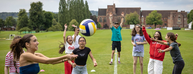 Paying volleyball dring a stay at Ardingly College Girls and boys play volleyball on a sports ground of Ardingly College